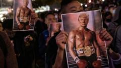 Hong Kong Protestors wave Trump Rocky photos at rally