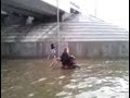Russia - Dog Pushes Owner In Wheelchair Through Flooded Street